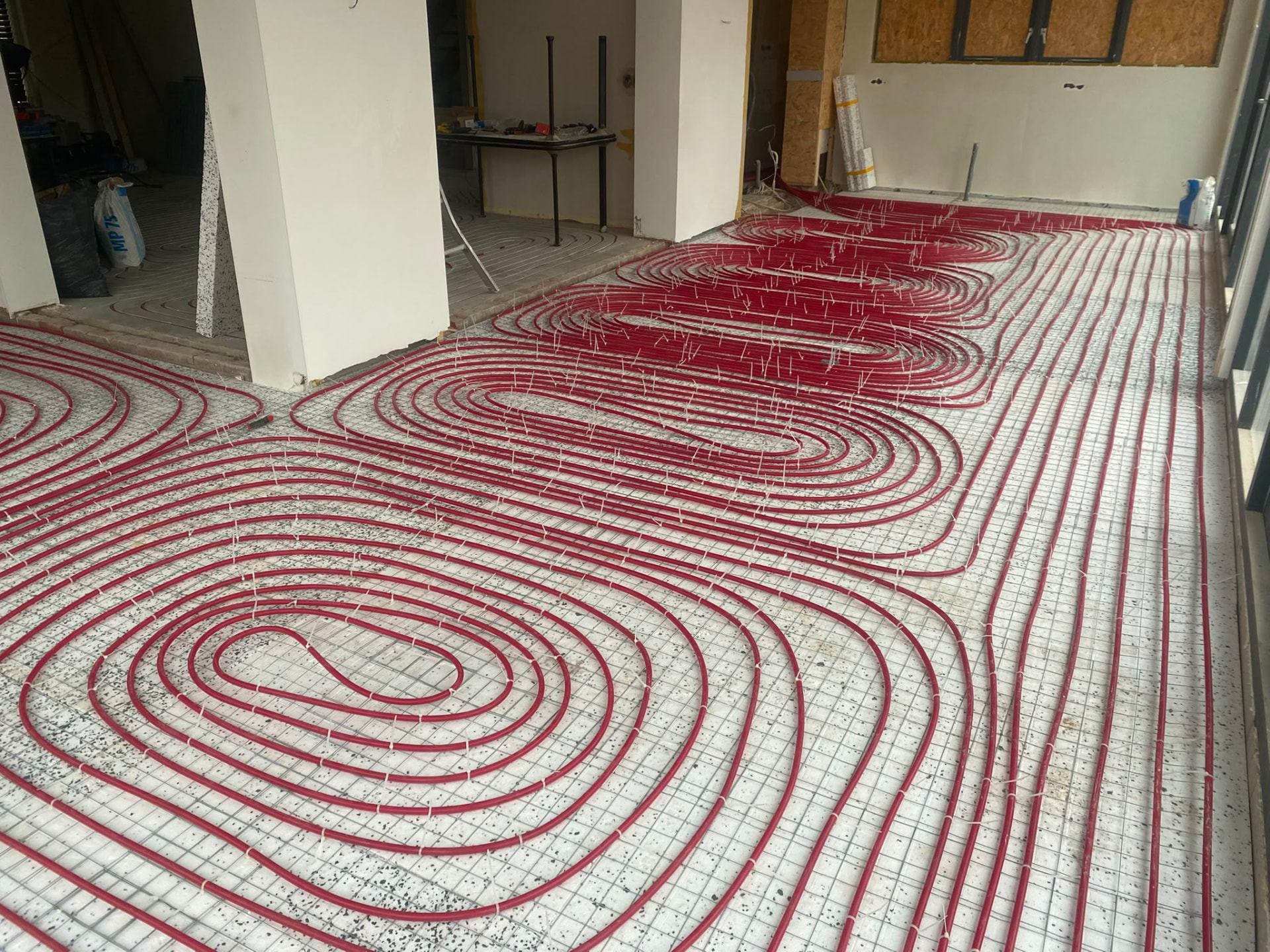 Underfloor heating pipes installed across a full ground floor during renovation